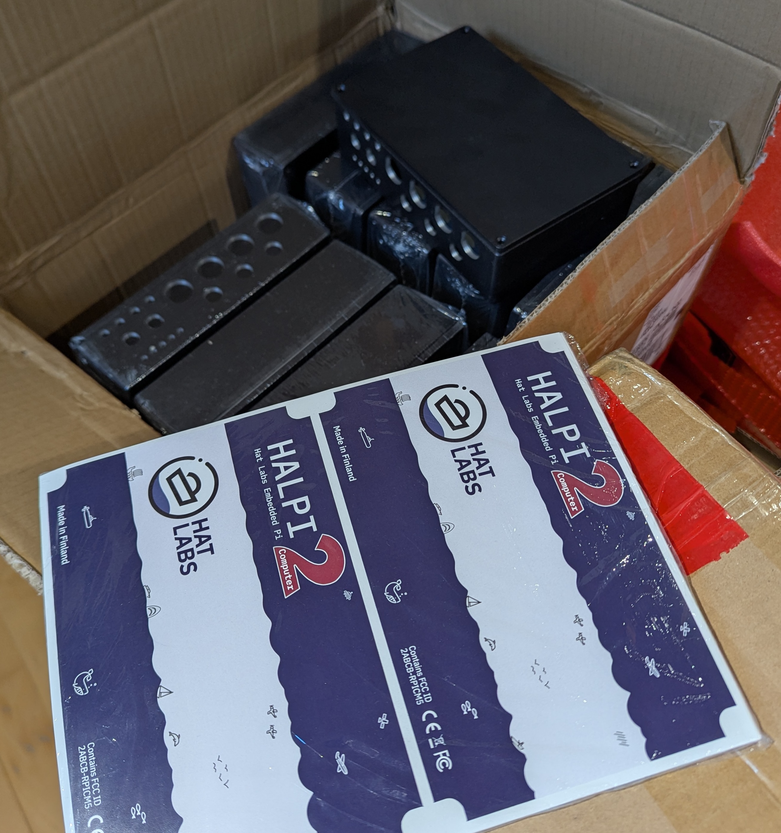 A box of HALPI2 enclosures with some stickers on top